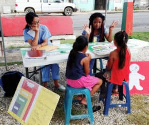 Students work outdoors with young children