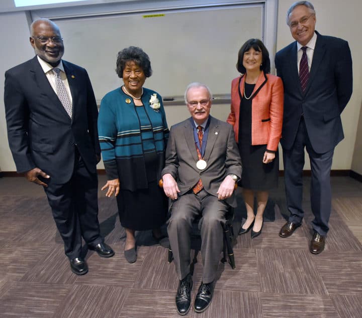 James M. Raczynski, PhD (seated), dean of the UAMS College of Public Health and colleagues